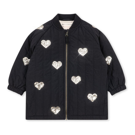 Konges Sløjd Winterjas Juno Sequin Long Jacket Black, lange zwarte winterjas met pailletten op witte achtergrond
