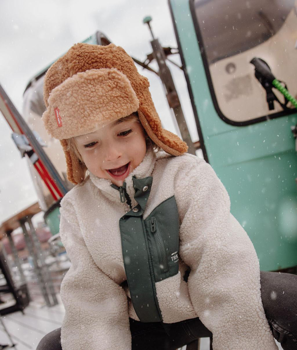 Hello Hossy muts met oorbescherming Cozy Sven, kind met muts bij de skilift